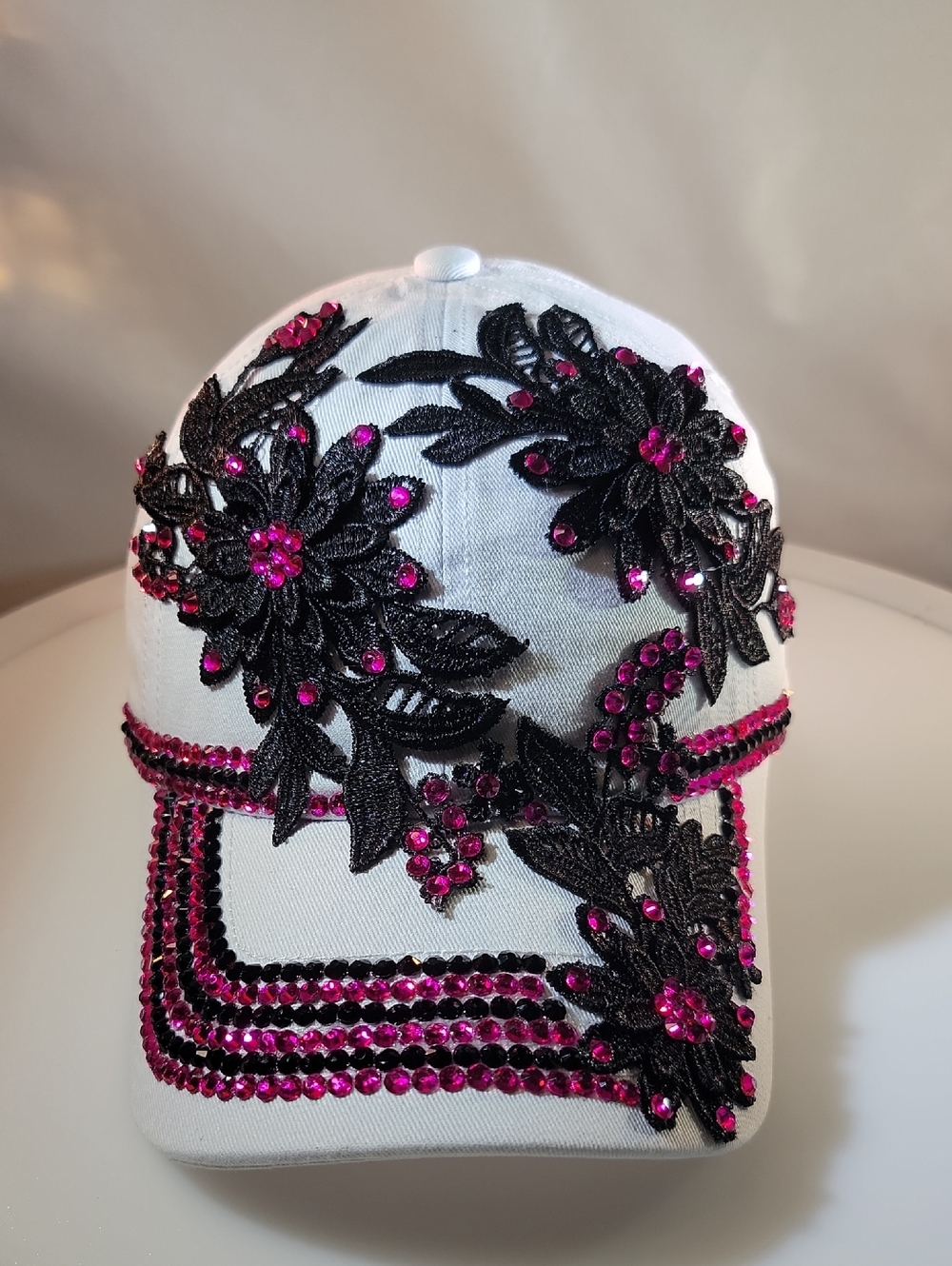 White Cap with Black Floral Appliqué and Fuchsia Crystal Accents